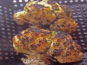 [Now I have hot spots and look a the char we are putting on the wood fired cauliflower. The green is the Parsley I add at the end of the process]