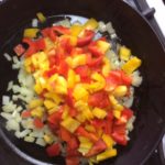 The peppers, onions and Potatoes in the skillet