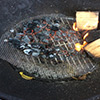 preparing the hot coals for the eggplant. you want these to burn down leaving only the heat and no flame to burn the eggplant. Ember cooking is only over hot coals.