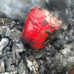  Whole organic Red Bell pepper purchased from the local Farmers Market, roasting directly on the smoking embers to add a tasty char flavor! 