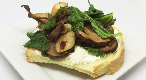 Mushrooms Go Smoky- baby bellas, cremini and shiitake mushrooms are stove top smoked and served over toast with a dolop of ricotta cheese. 