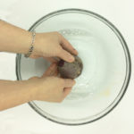 Washing the beets to remove any ground soil.
