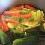 Our Smoked beef bones in the pot simmering with vegetables!