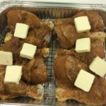 the drumsticks with the dry rub applied and patties of butter on top