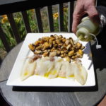 Chef Calle drizzling extra virgin olive oil over the squid and Mussels