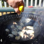 Grilling over the hottest part of the fire and spritz with lemon