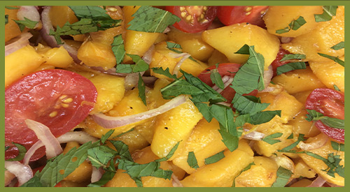 Our Grilled Peaches for the perfect salad addition with sweet onion, Tomatoes, and fresh herbs!