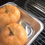 Our two pumpkins on the grill with the smoker box on the heated burners 