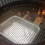 grill demonstrating our two zone charcoal grill set up with wood chunks