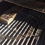two zone cooking method with smoker box on on side and cooking on the other 