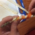 wrapping our Asparagus with carrot peel in preparation for the grill