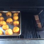 our tray of smoked peaches on the gas grill using a two zone cooking method to add wood smoke flavor. 