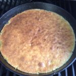 Our upside down cake baking in the cast iron pan on the gas grill 
